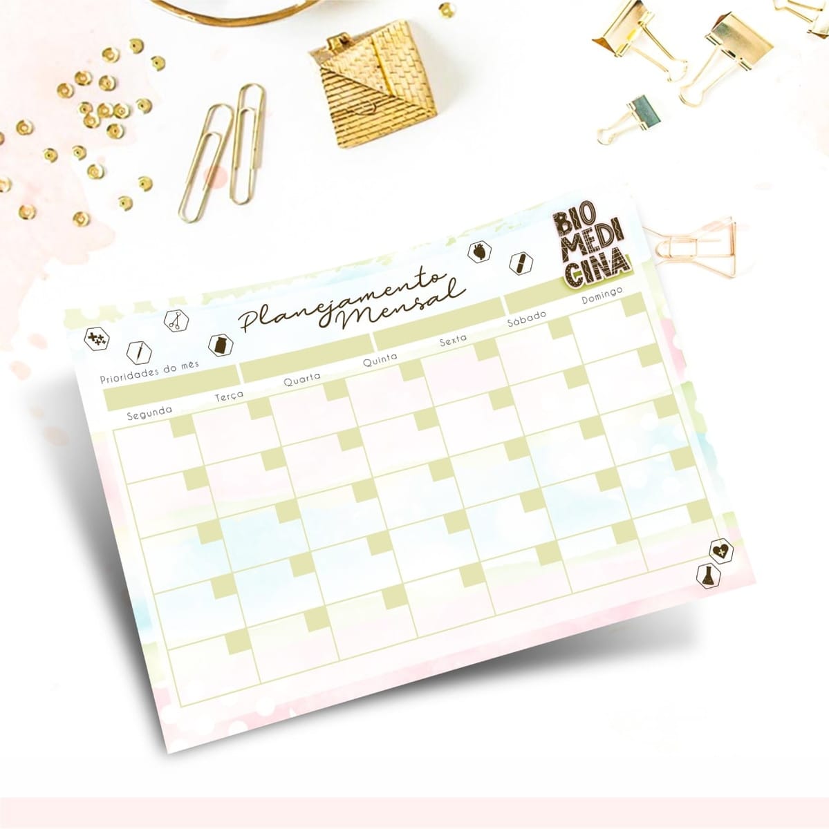 Caderno Digital Biomedicina com Stickers e Planner 4 Folha de planejamento mensal com dias da semana e pequenos grampos ao redor.