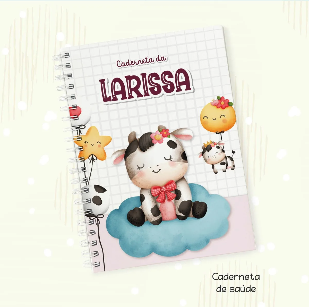 Caderneta personalizada com ilustrações de vaquinha fofa, estrela e balão em fundo quadriculado.