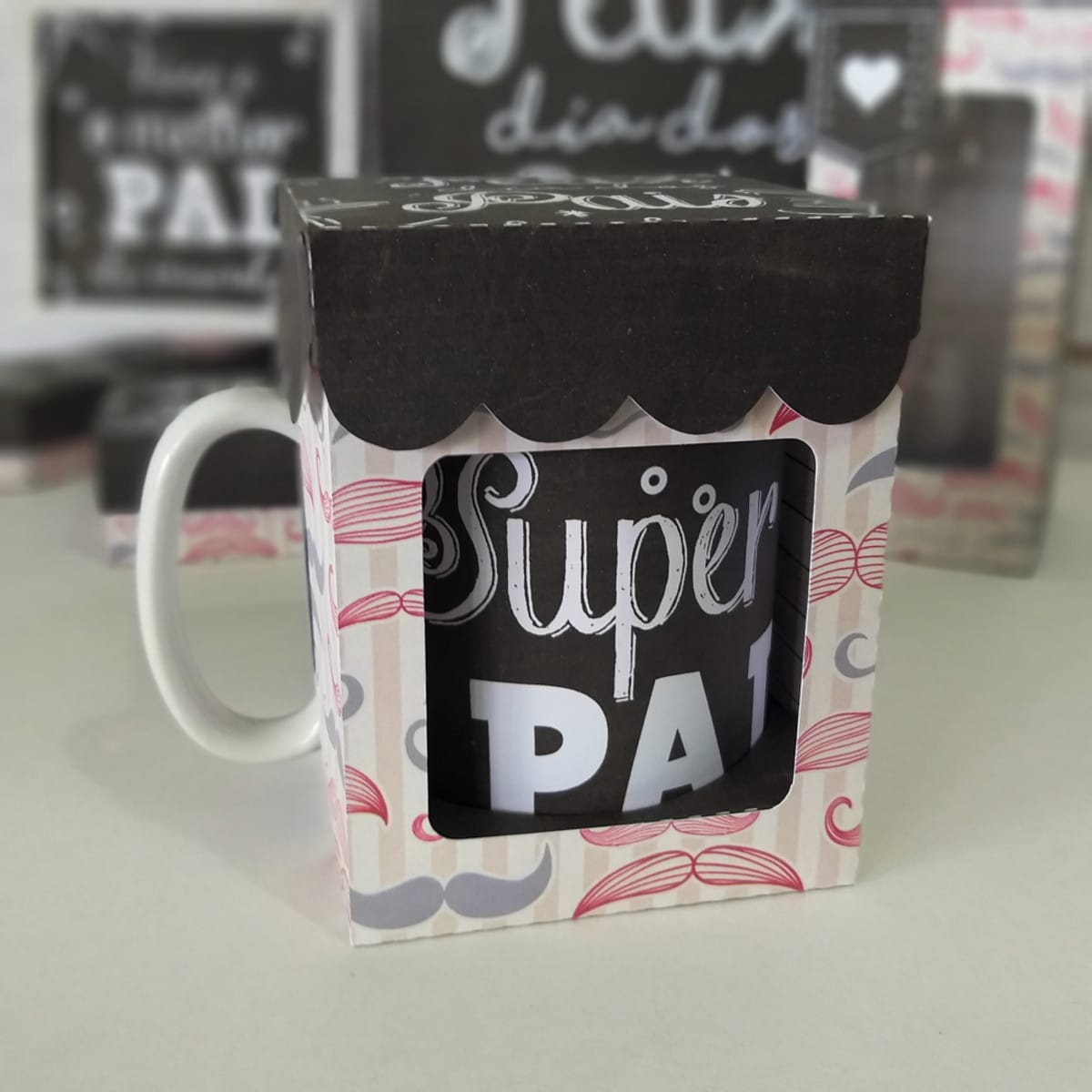 Kit Digital Dia dos Pais Editável PDF e Studio 3 Caneca preta com escrita branca dentro de uma caixinha de papel personalizada.