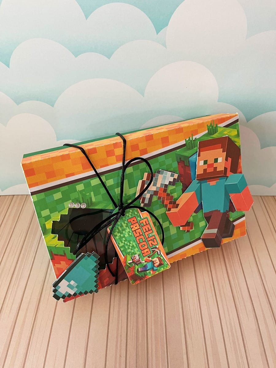Mini Confeiteiro Minecraft Arquivo Digital para Imprimir 5 Arte digital de caixa decorada com tema de jogo pixelizado e tag "Feliz Páscoa".