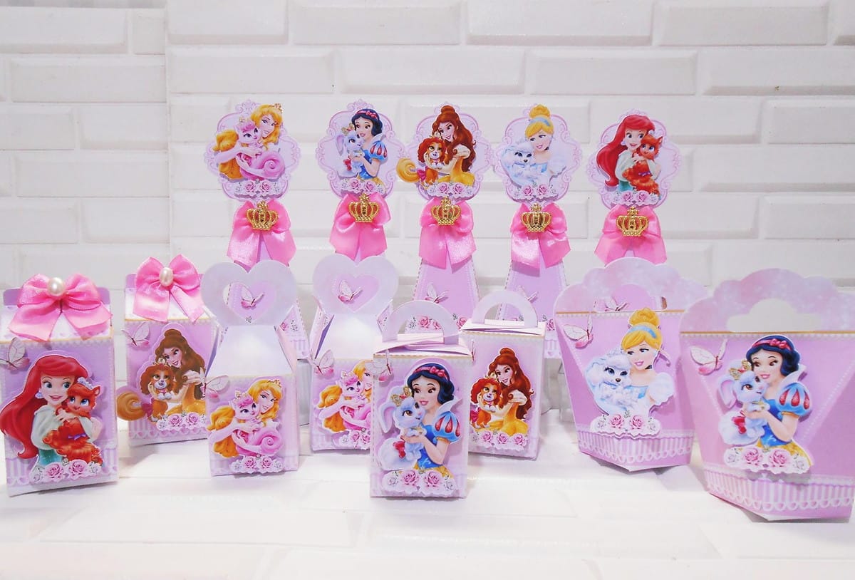 Monte uma Festa Princesas Disney com Kit Digital Completo 1 Conjunto de caixas e enfeites decorativos rosados com ilustrações de princesas.